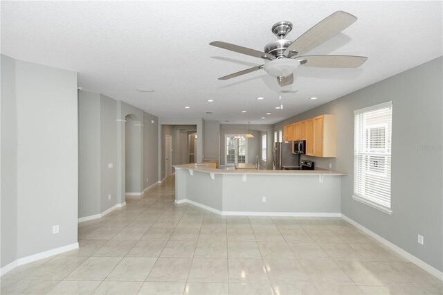 6728 Duncaster St, Windermere, FL 34786 - kitchen with appliances with stainless steel finishes, healthy amount of natural light, light brown cabinets, a peninsula, and recessed lighting