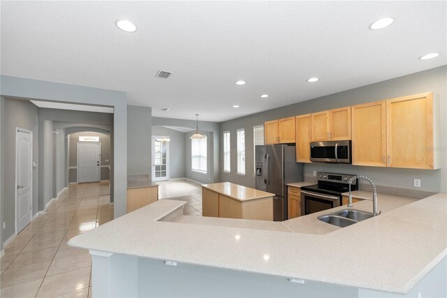 6728 Duncaster St, Windermere, FL 34786 - kitchen featuring stainless steel appliances, light tile patterned floors, a center island, recessed lighting, and a sink