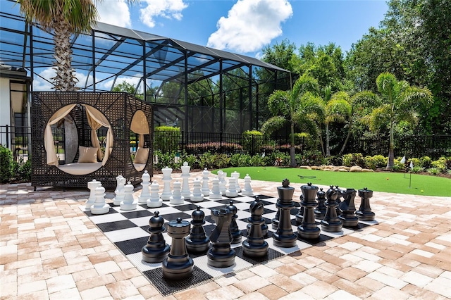 view of patio featuring a putting green and fence