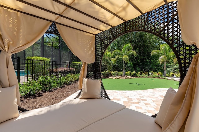 view of patio / terrace featuring an area to practice putting and fence