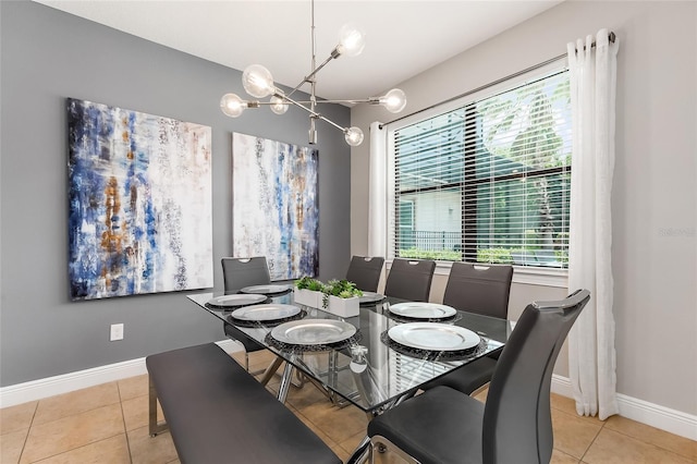 dining room with tile patterned flooring, a chandelier, and baseboards