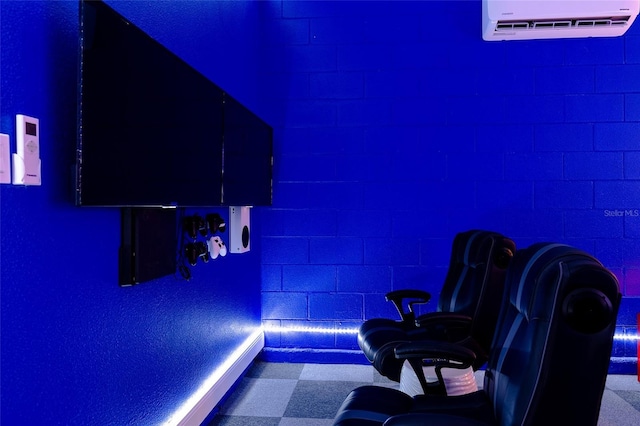 cinema room featuring tile patterned floors and a wall unit AC