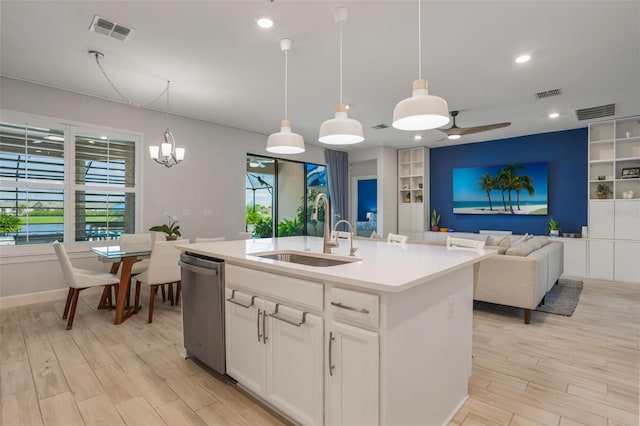 636 San Augusto Dr, Kissimmee, FL 34759 - kitchen featuring a sink, stainless steel dishwasher, light wood-style flooring, built in shelves, and light countertops
