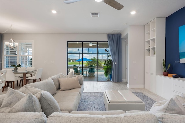 636 San Augusto Dr, Kissimmee, FL 34759 - living area with a chandelier, a ceiling fan, light wood-style floors, and recessed lighting
