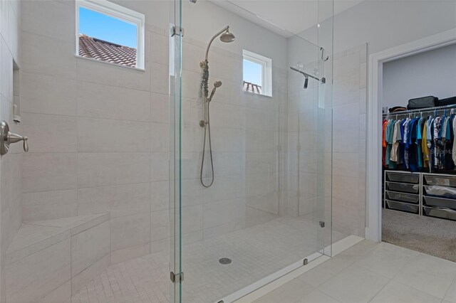 636 San Augusto Dr, Kissimmee, FL 34759 - bathroom with a stall shower, a spacious closet, and tile patterned floors