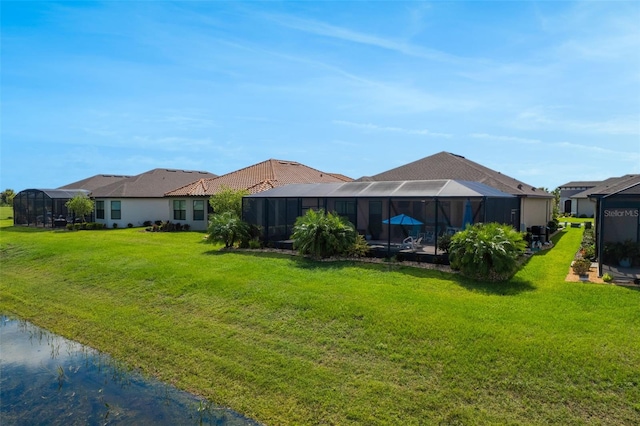 636 San Augusto Dr, Kissimmee, FL 34759 - rear view of property with a lawn, glass enclosure, and a residential view