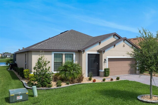 636 San Augusto Dr, Kissimmee, FL 34759 - single story home with roof with shingles, an attached garage, stucco siding, and a front yard