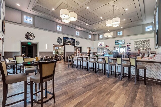 636 San Augusto Dr, Kissimmee, FL 34759 - dining area featuring wood finished floors, a high ceiling, coffered ceiling, and recessed lighting