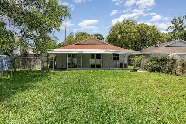 back of property with a sunroom and central AC