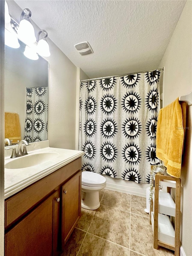 1474 Lakeside Ave, Davenport, FL 33837 - bathroom featuring vanity, toilet, a textured ceiling, and tile patterned floors