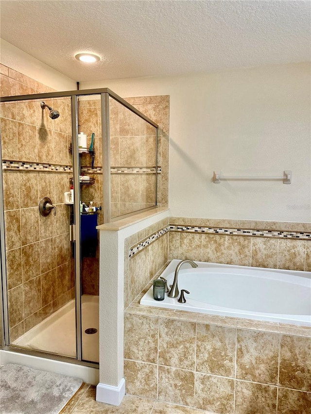1474 Lakeside Ave, Davenport, FL 33837 - bathroom with a garden tub, a textured ceiling, and a shower stall