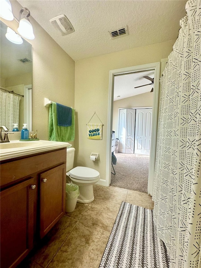 1474 Lakeside Ave, Davenport, FL 33837 - full bathroom with vanity, toilet, tile patterned floors, vaulted ceiling, and a shower with shower curtain
