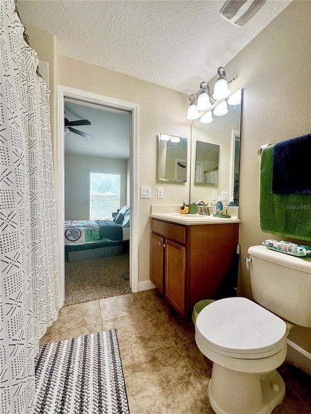 1474 Lakeside Ave, Davenport, FL 33837 - ensuite bathroom with vanity, toilet, a textured ceiling, and tile patterned floors
