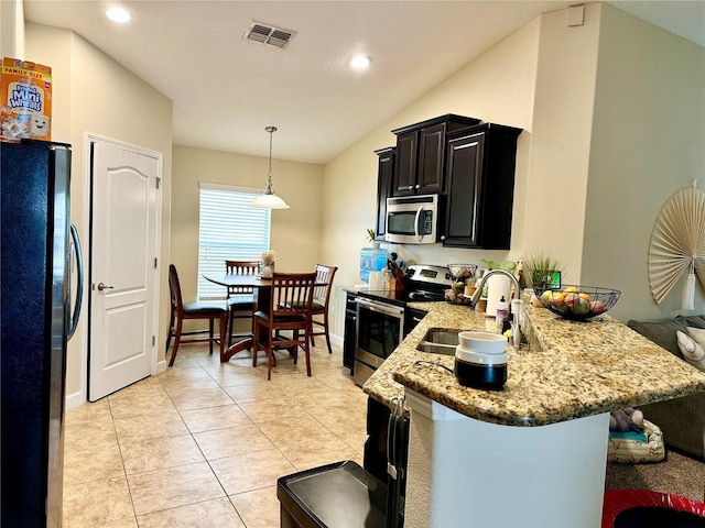 1474 Lakeside Ave, Davenport, FL 33837 - kitchen with appliances with stainless steel finishes, a sink, dark cabinets, a peninsula, and light stone countertops