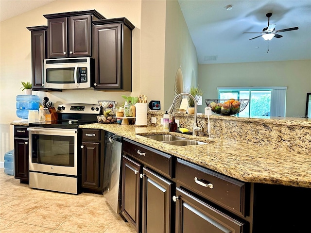 1474 Lakeside Ave, Davenport, FL 33837 - kitchen with stainless steel appliances, a sink, light stone counters, a ceiling fan, and lofted ceiling