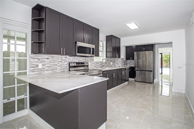 4324 Garden Ave, West Palm Beach, FL 33405 - kitchen featuring stainless steel appliances, backsplash, open shelves, a peninsula, and light marble finish floors