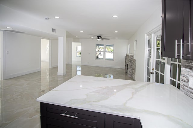 4324 Garden Ave, West Palm Beach, FL 33405 - kitchen with open floor plan, dark cabinetry, recessed lighting, a ceiling fan, and light stone counters