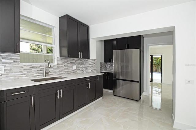 4324 Garden Ave, West Palm Beach, FL 33405 - kitchen with freestanding refrigerator, a sink, plenty of natural light, and light marble finish flooring