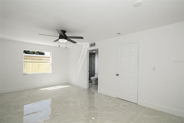 4324 Garden Ave, West Palm Beach, FL 33405 - unfurnished bedroom featuring baseboards, light marble finish flooring, ensuite bathroom, and ceiling fan