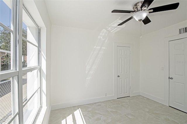 4324 Garden Ave, West Palm Beach, FL 33405 - spare room featuring baseboards, light marble finish floors, and a ceiling fan