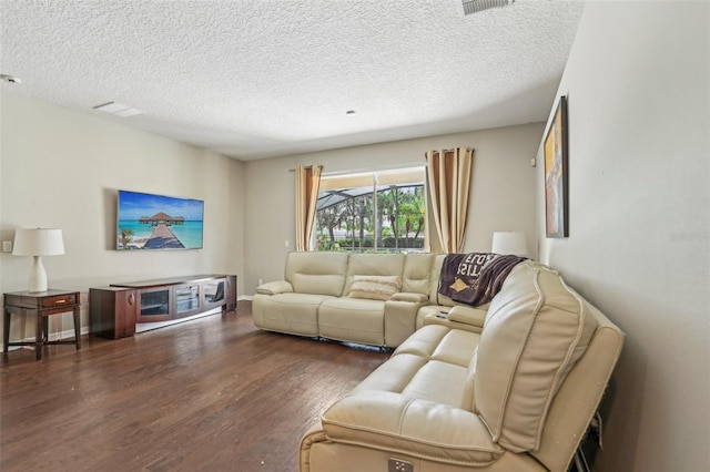 living area with wood finished floors and a textured ceiling
