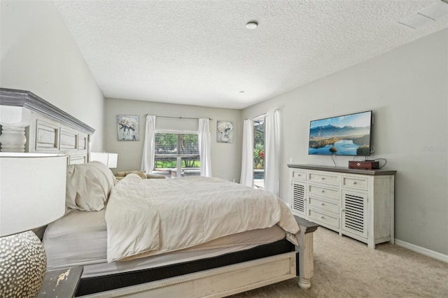 bedroom featuring access to exterior, light colored carpet, a textured ceiling, and baseboards
