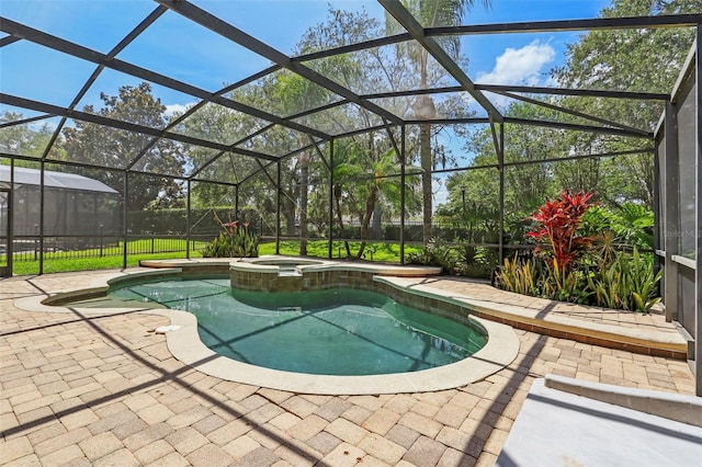view of swimming pool with a patio area, a pool with connected hot tub, and a lanai