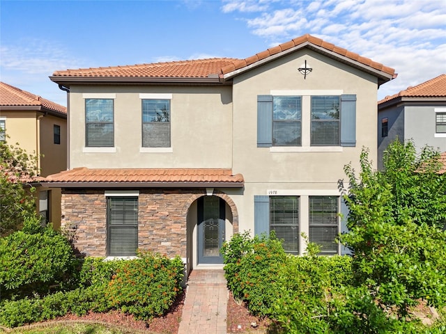 1978 Fishtail Fern Way, Ocoee, FL 34761 - mediterranean / spanish-style home with a tile roof, stucco siding, and stone siding