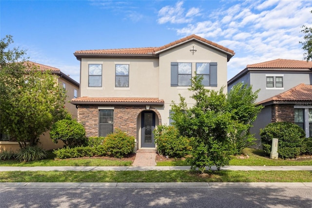 1978 Fishtail Fern Way, Ocoee, FL 34761 - mediterranean / spanish home featuring a tiled roof, stone siding, and stucco siding