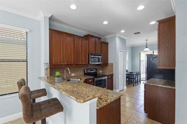 1978 Fishtail Fern Way, Ocoee, FL 34761 - kitchen featuring appliances with stainless steel finishes, a sink, decorative backsplash, light stone counters, and recessed lighting