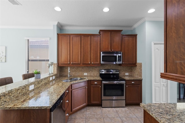 1978 Fishtail Fern Way, Ocoee, FL 34761 - kitchen with appliances with stainless steel finishes, a sink, backsplash, light stone countertops, and ornamental molding
