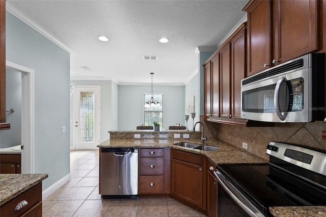 1978 Fishtail Fern Way, Ocoee, FL 34761 - kitchen featuring stainless steel appliances, a sink, a peninsula, a chandelier, and dark stone counters