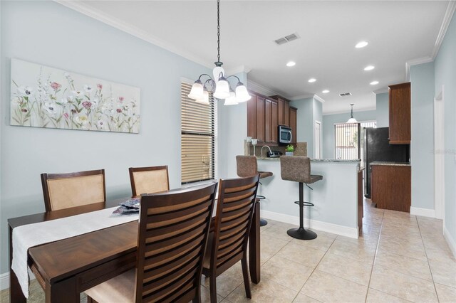 1978 Fishtail Fern Way, Ocoee, FL 34761 - dining area with a chandelier, ornamental molding, recessed lighting, light tile patterned flooring, and baseboards