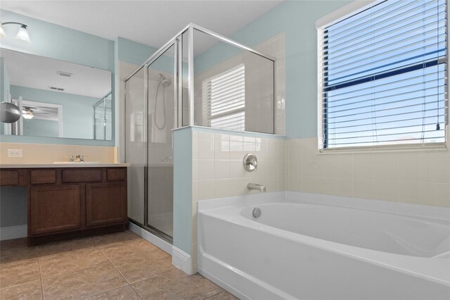 1978 Fishtail Fern Way, Ocoee, FL 34761 - bathroom featuring vanity, a stall shower, a garden tub, and a ceiling fan