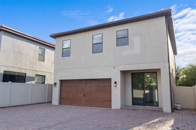 1978 Fishtail Fern Way, Ocoee, FL 34761 - rear view of property with stucco siding, a garage, fence, and decorative driveway