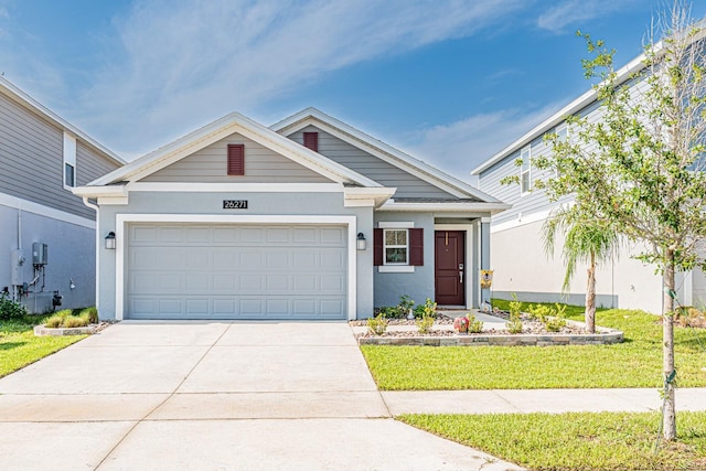 ranch-style house with stucco siding, driveway, a garage, and a front lawn
