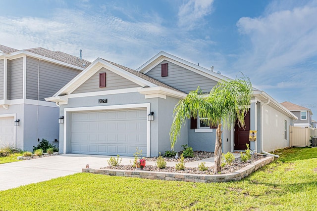 single story home featuring driveway, a front lawn, an attached garage, and stucco siding