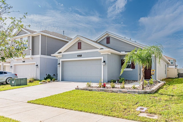 view of front of property with a front lawn, driveway, stucco siding, and an attached garage