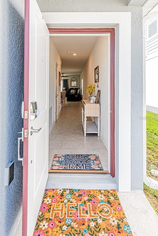 doorway to property with stucco siding