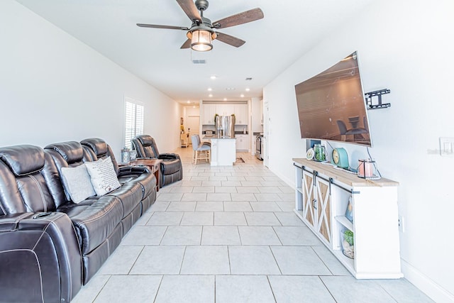 living area featuring ceiling fan, baseboards, light tile patterned flooring, and recessed lighting