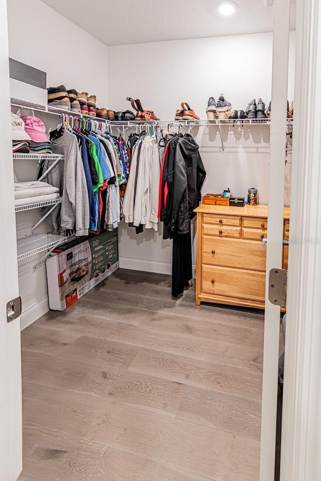spacious closet with wood finished floors
