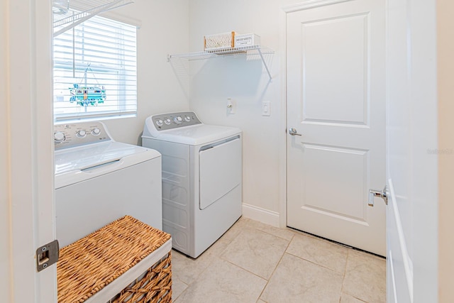 washroom featuring washer and dryer and light tile patterned floors