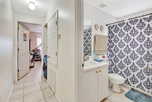 6528/6530 12th St W, Bradenton, FL 34207 - bathroom featuring tile patterned flooring, toilet, vanity, curtained shower, and baseboards