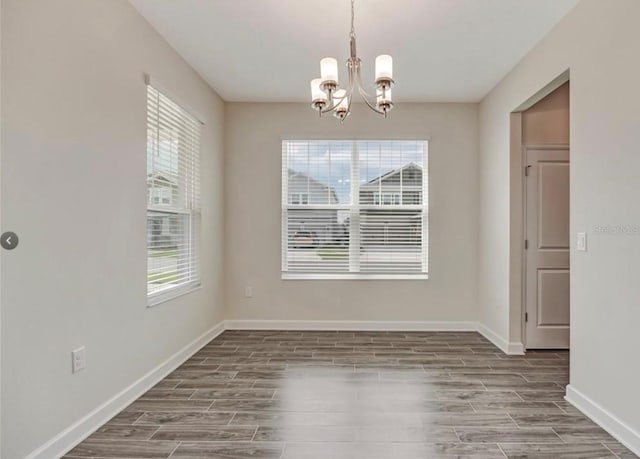 11807 Charades St, Orlando, FL 32832 - unfurnished dining area with a chandelier, wood finished floors, and plenty of natural light