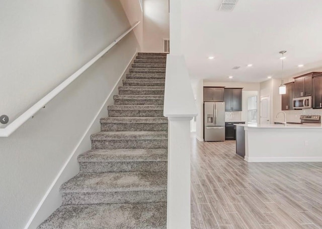 11807 Charades St, Orlando, FL 32832 - stairs featuring wood finished floors and recessed lighting