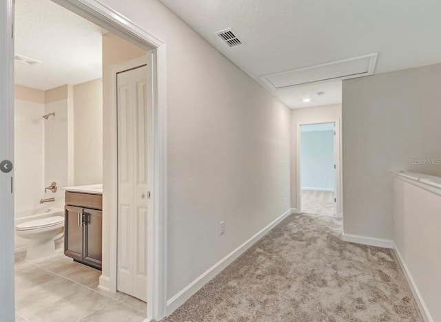 11807 Charades St, Orlando, FL 32832 - hallway featuring attic access, baseboards, and light carpet