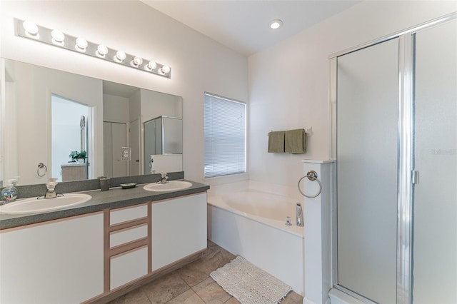 bathroom with a stall shower, a bath, and double vanity