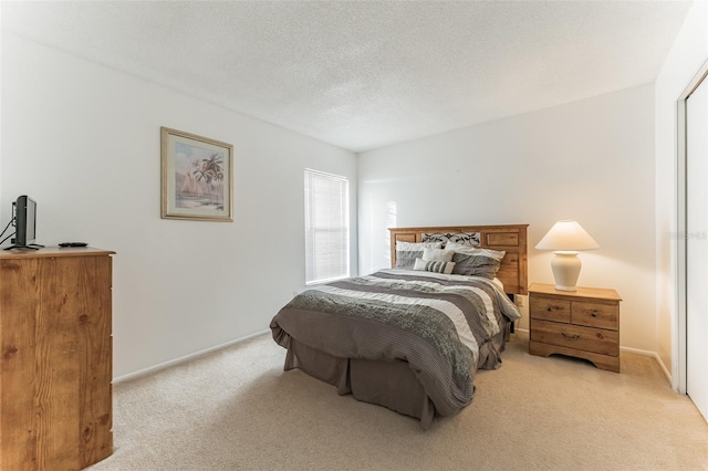 bedroom featuring light carpet and baseboards