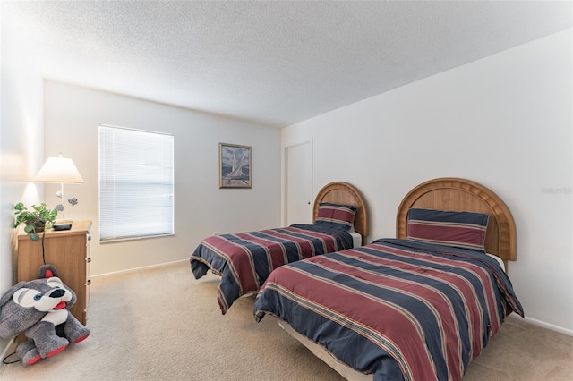 carpeted bedroom with baseboards and a textured ceiling