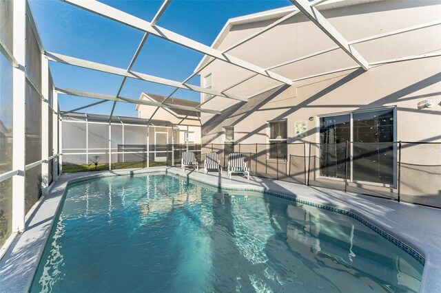 view of swimming pool with a patio and a lanai